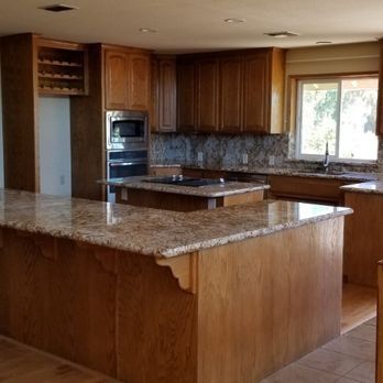 Spacious kitchen with wood cabinets, granite island, and stainless steel appliances