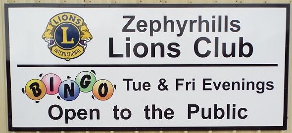 A sign that says zephyrhills lions club open to the public