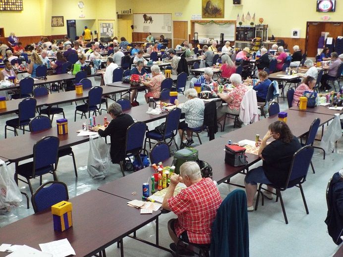 A large group of people are sitting at tables in a large room