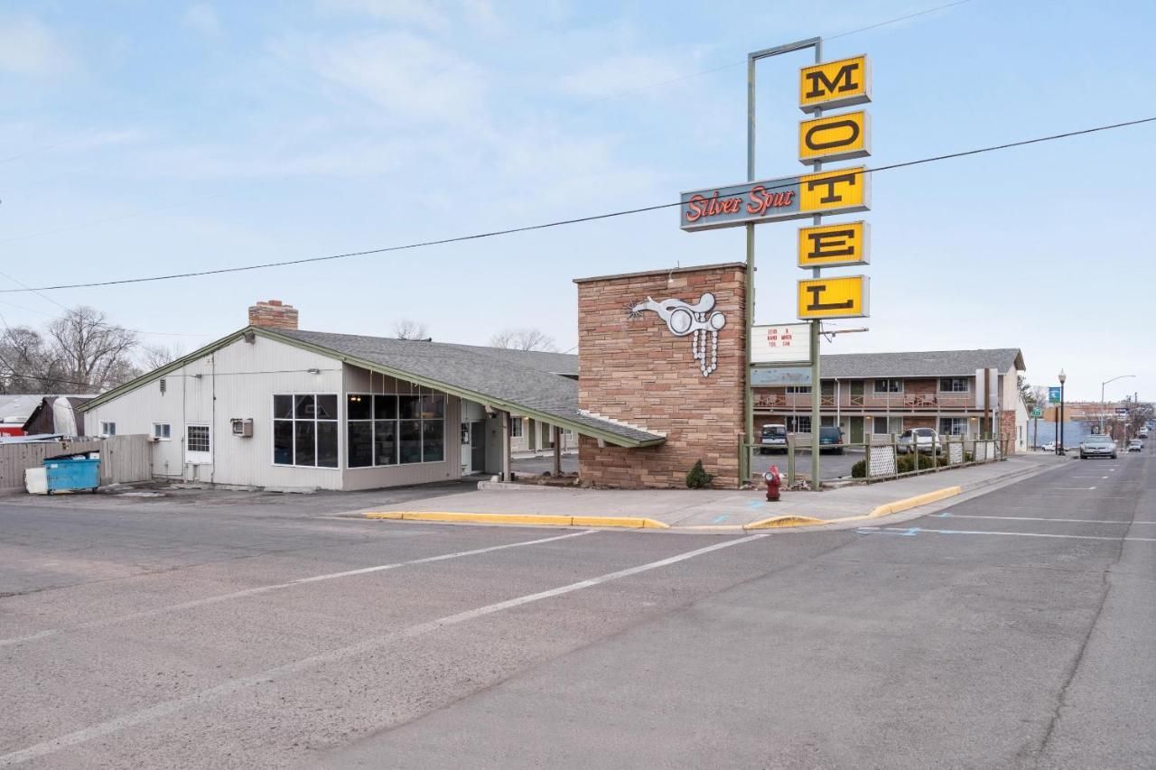 A motel is located on the corner of a street in a small town.