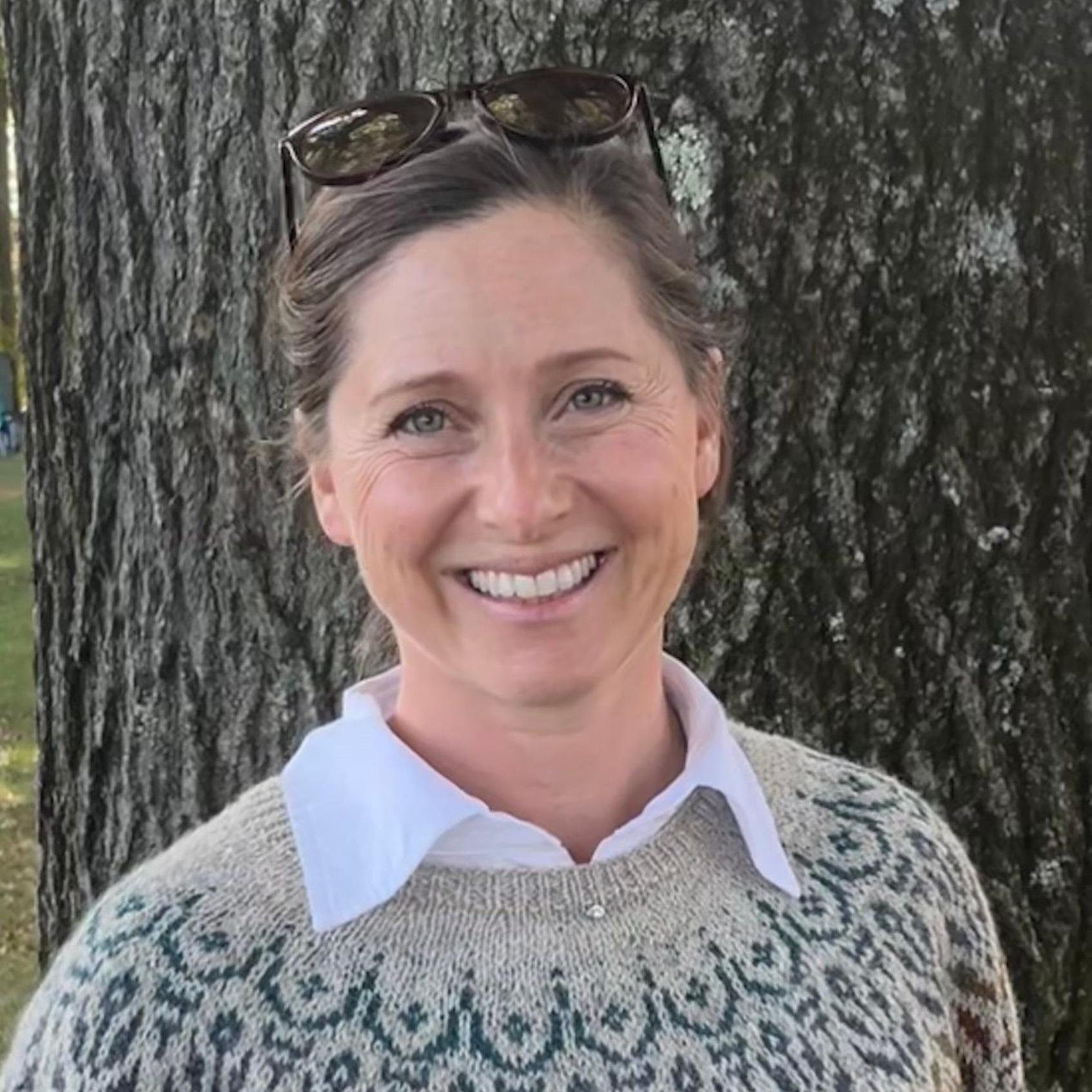 Woman wearing glasses and a tie-dye shirt with