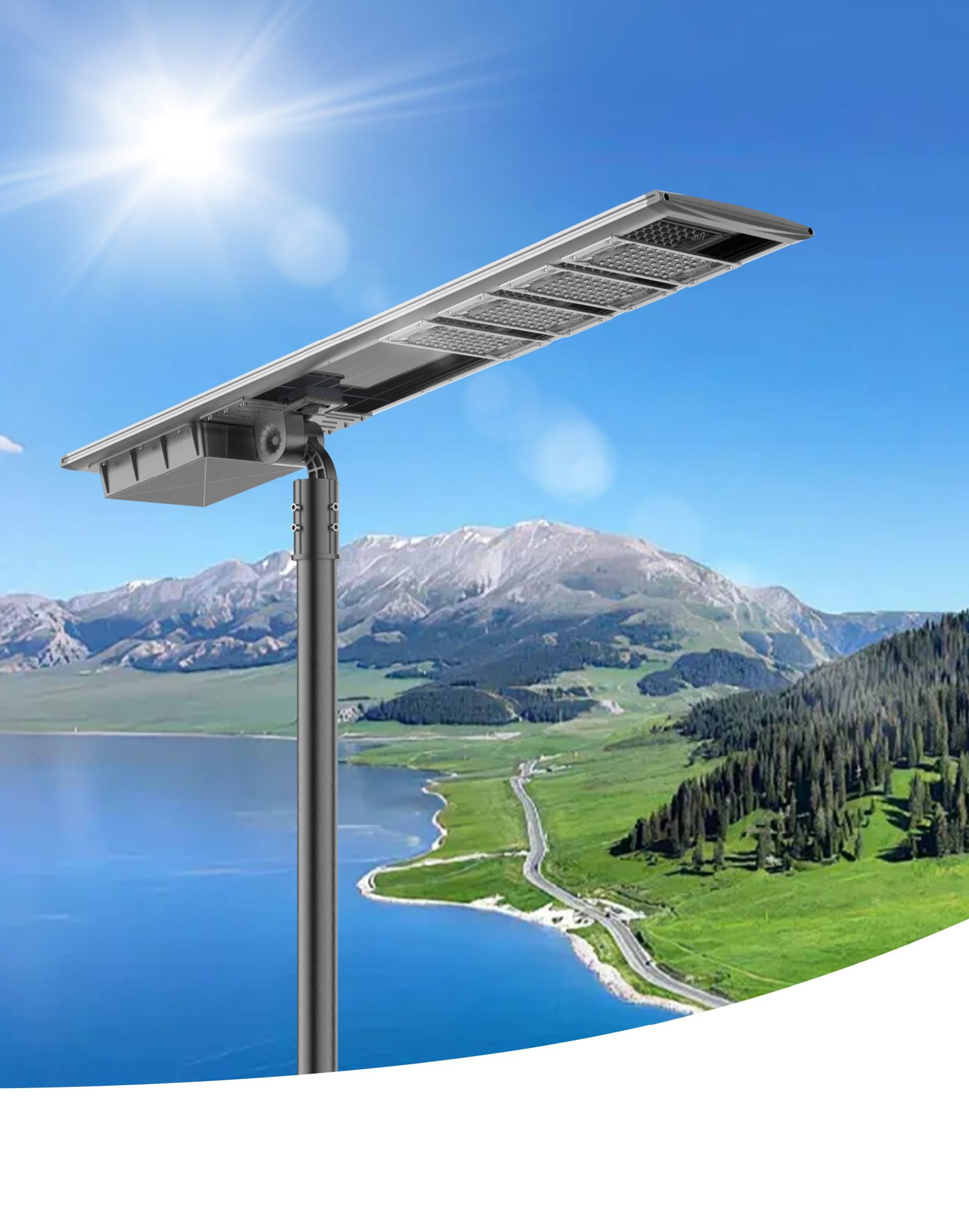 Solar-powered street light against a scenic landscape of mountains, lake, road, and blue sky.