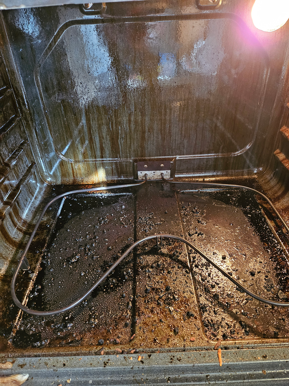 The inside of an oven is very dirty and needs to be cleaned.