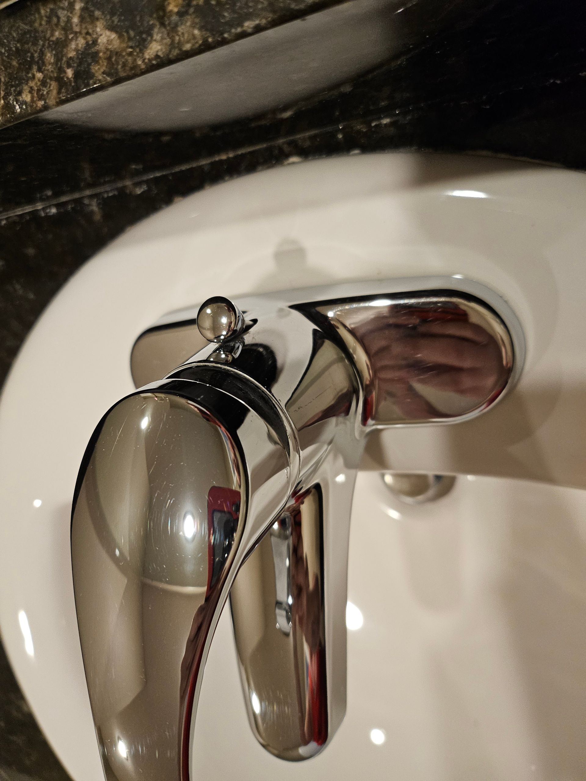 A close up of a bathroom sink with a chrome faucet