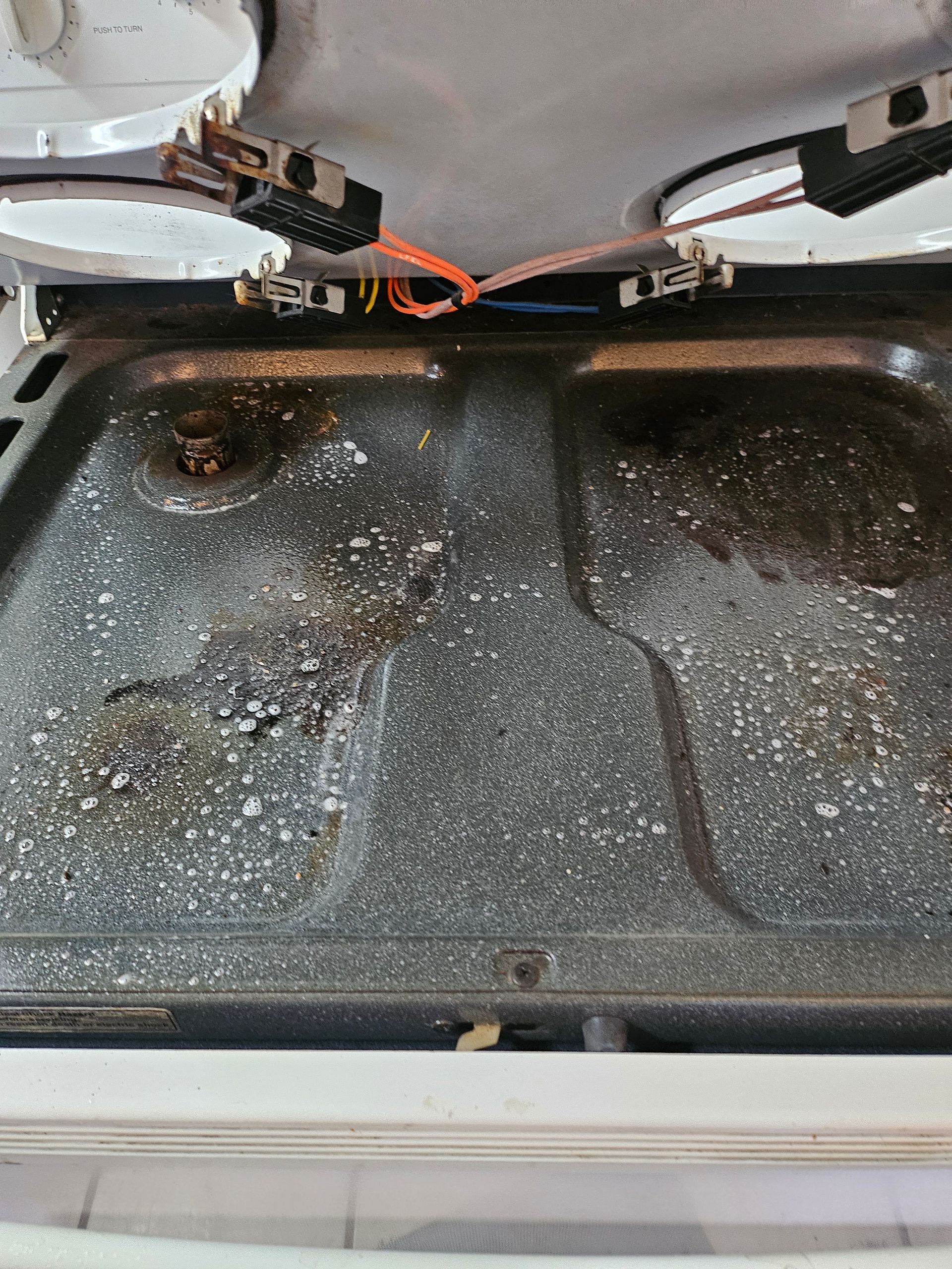 A close up of a stove top oven with the door open.