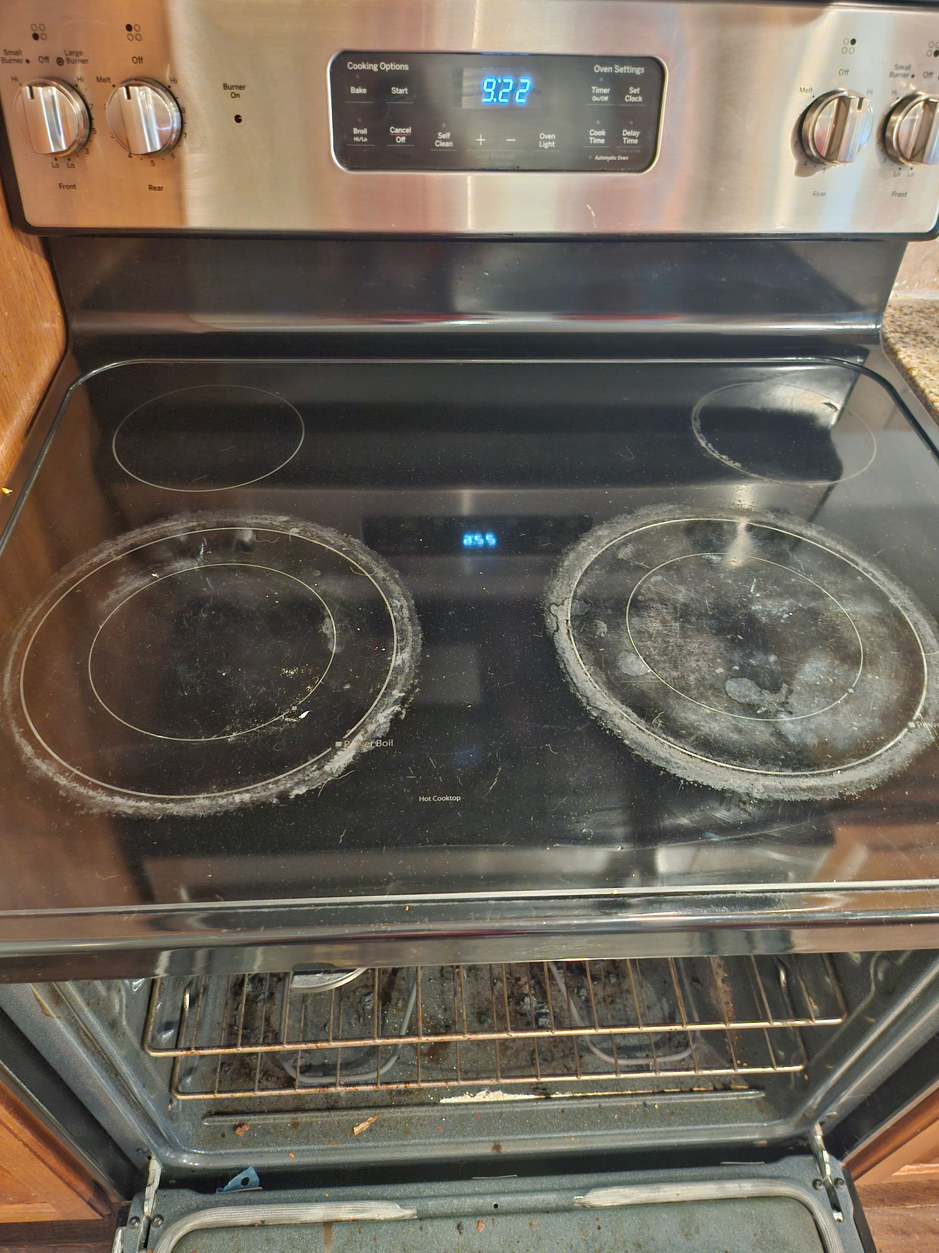 A stainless steel stove with two burners and an oven.