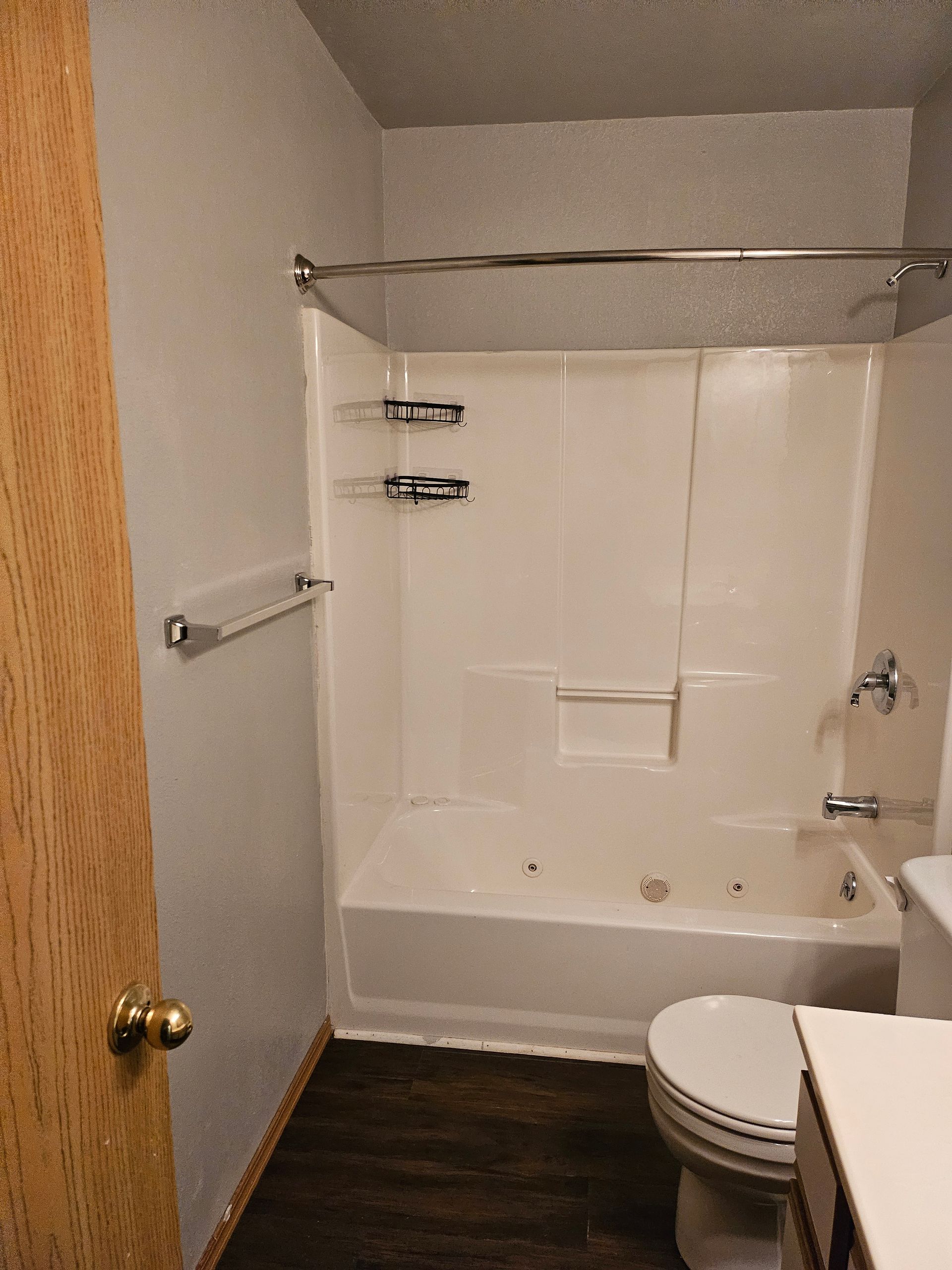 A bathroom with a tub , toilet and sink