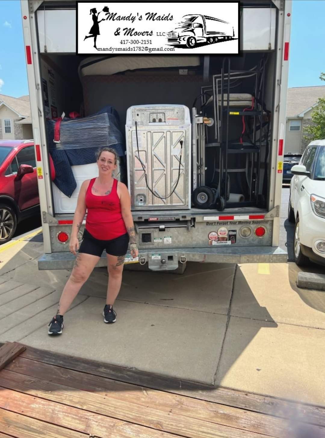 A woman is standing in front of a moving truck.