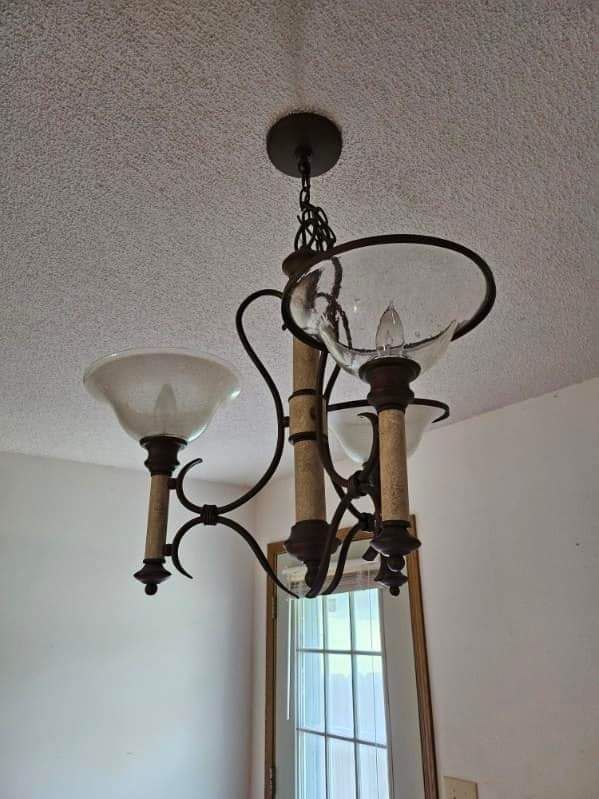 A chandelier is hanging from the ceiling in a room