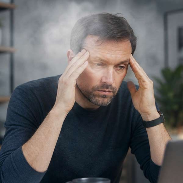 Man with Brain Fog at his desk at work