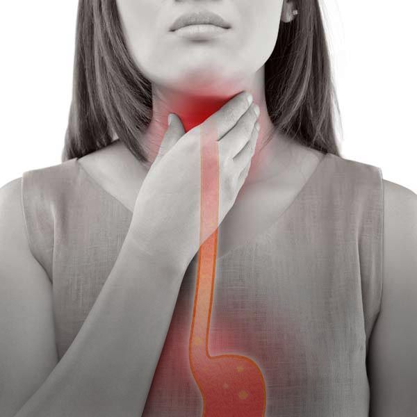 Woman holding throat, red highlighting shows throat and esophagus, possible acid reflux.