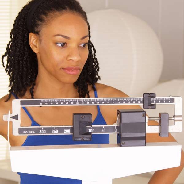 A black woman unhappy with her weight loss efforts due to insulin resistance