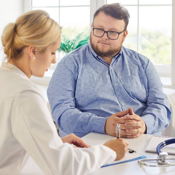 Obese male patient checking in for a health evaluation