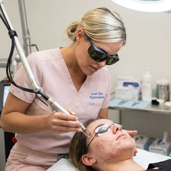 Helene Salerno performing a laser skin rejuvenation treatment on a patient's face at Salerno Wellness in NYC