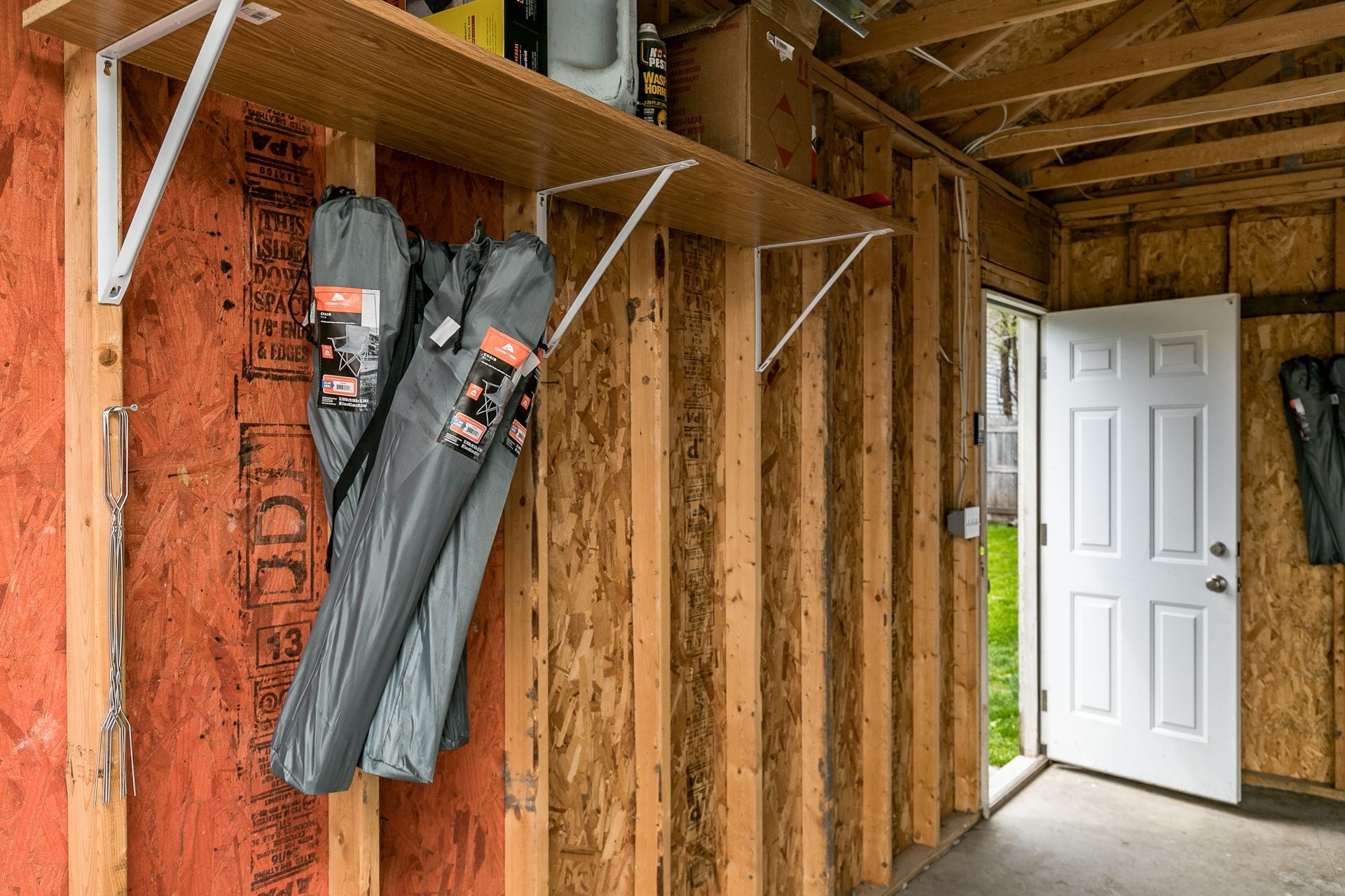 The Stadium House garage interior with door