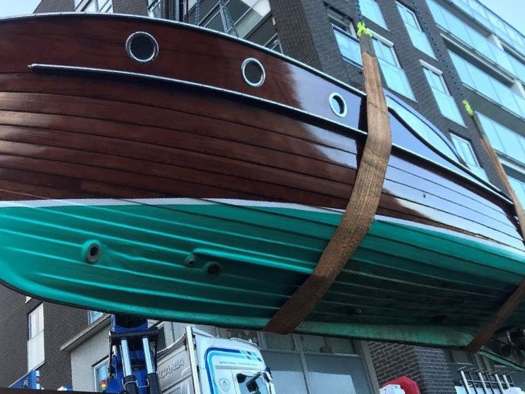 A jet thruster nozzle visible in a wooden boat. Nozzle clearly visible in the bow