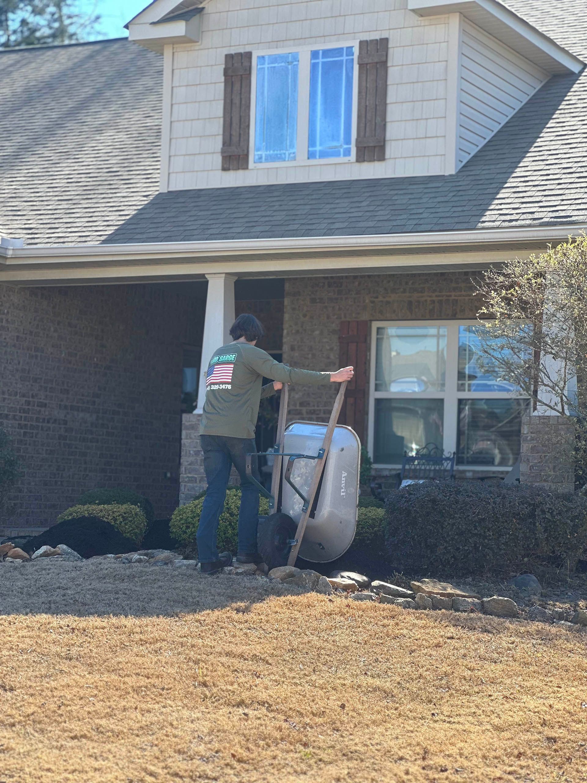 Worker loading a large package at a suburban house entrance