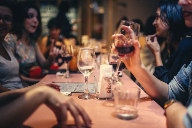 People drinking a glass of wine
