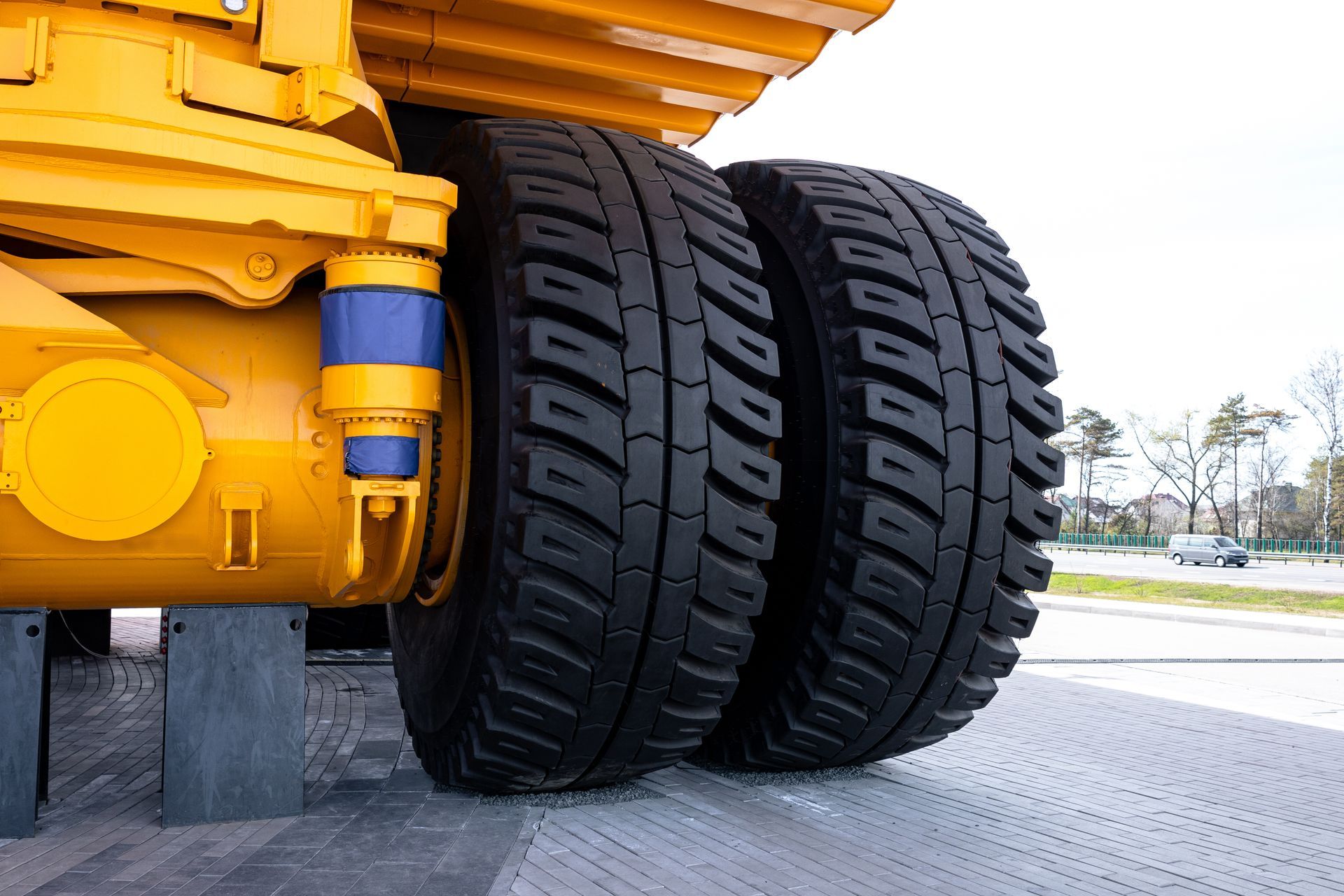 Stacked truck tires in a workshop beside a parked semi-truck