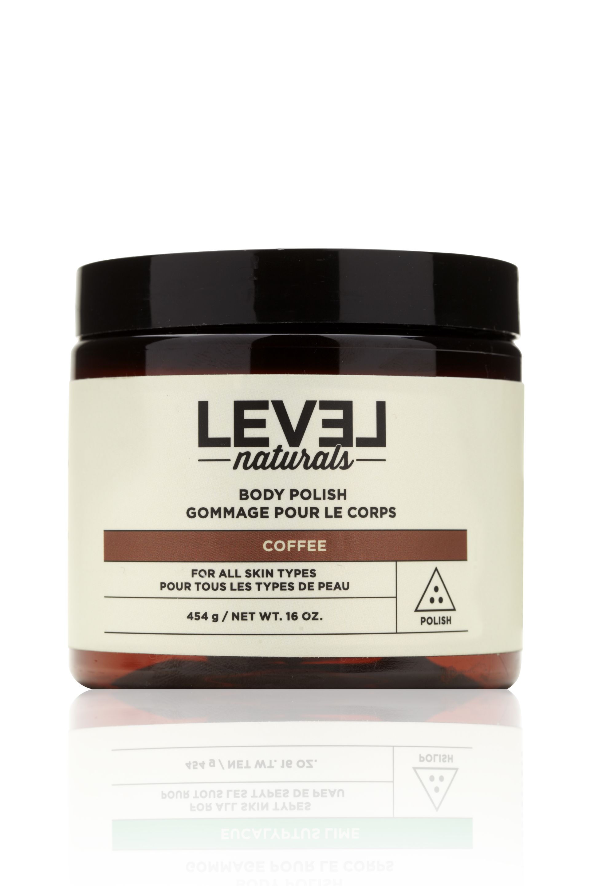 A jar of level naturals body polish is sitting on a white surface.