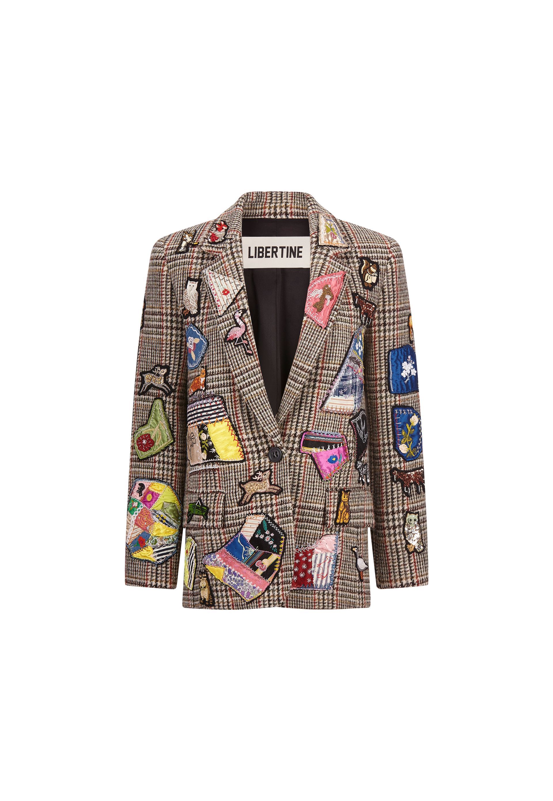 A blazer with a lot of patches on it on a white background.