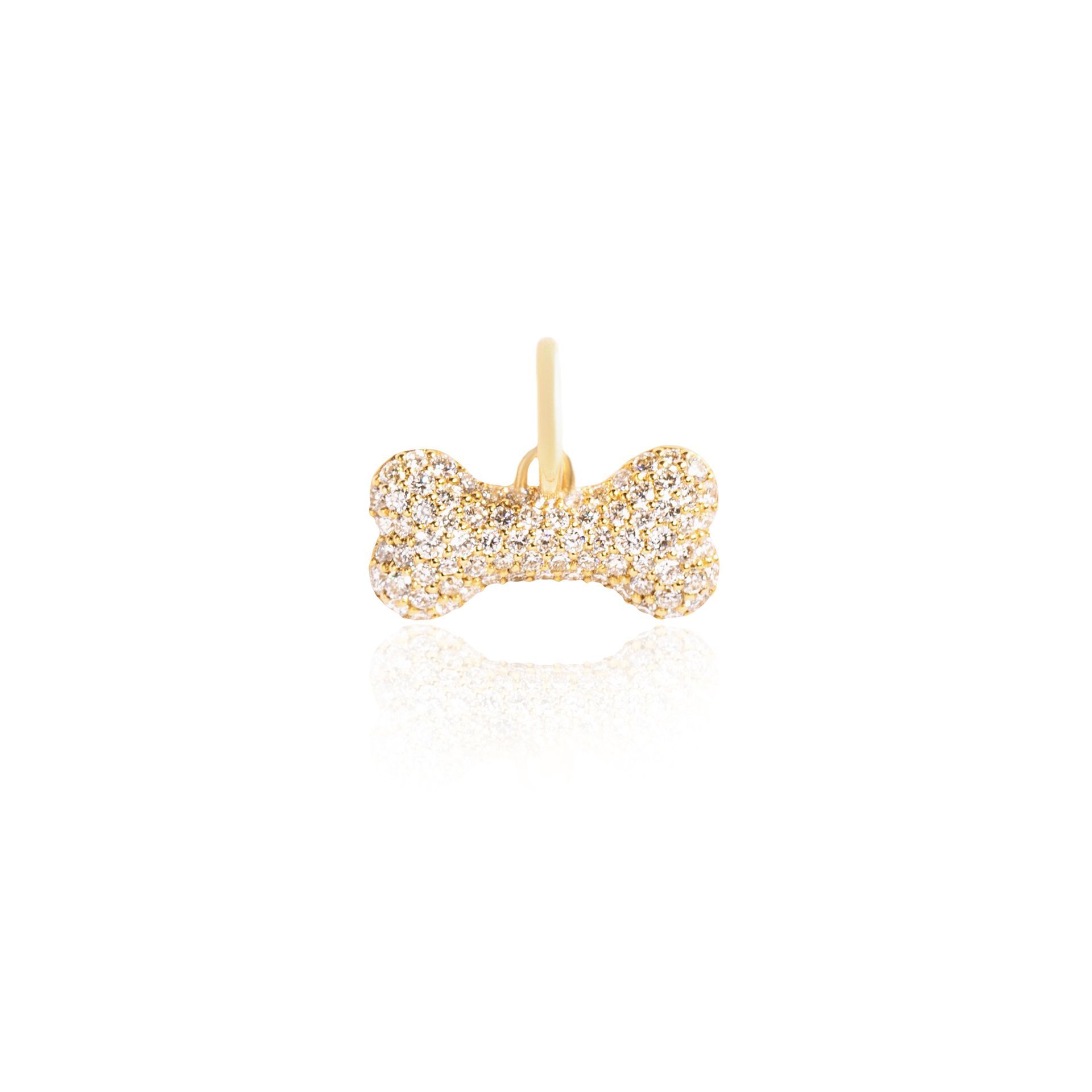 A gold pendant in the shape of a dog bone