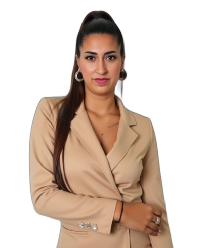 Woman with long brown hair in a tan blazer, looking at the camera. Black background.
