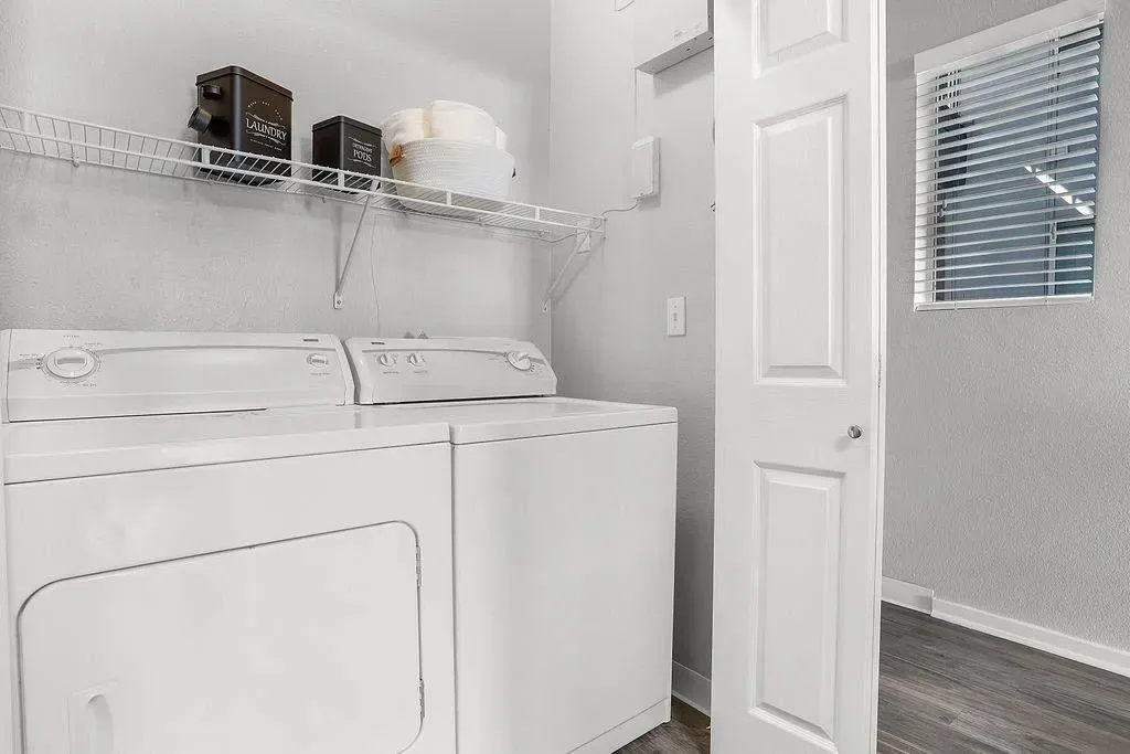 In-unit laundry room with washer and dryer stacked at Solaire, offering apartments in Albuquerque, NM.