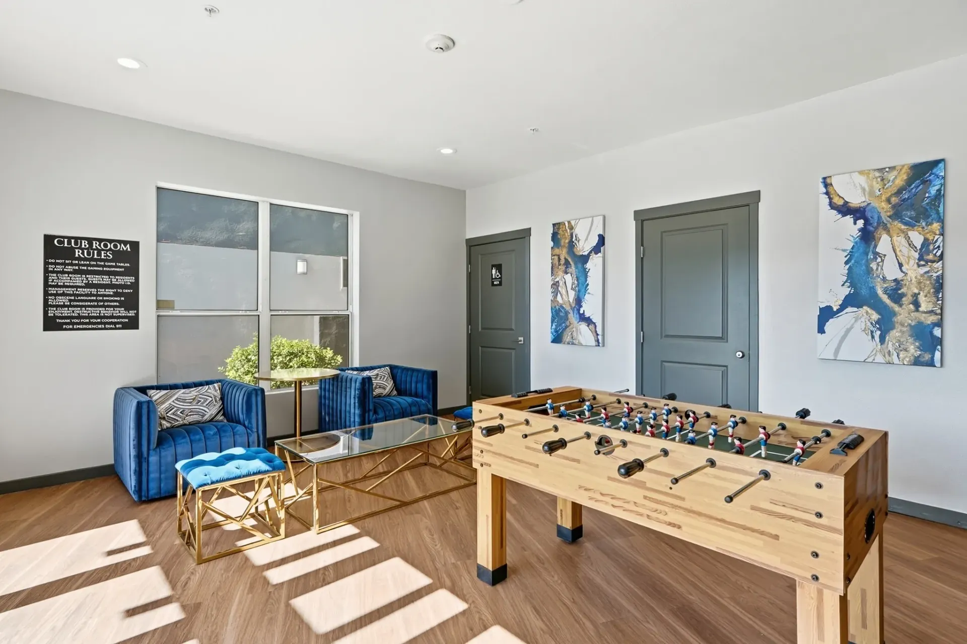 Club room with foosball table, seating area, and abstract art at Solaire, offering apartments in Albuquerque, NM.