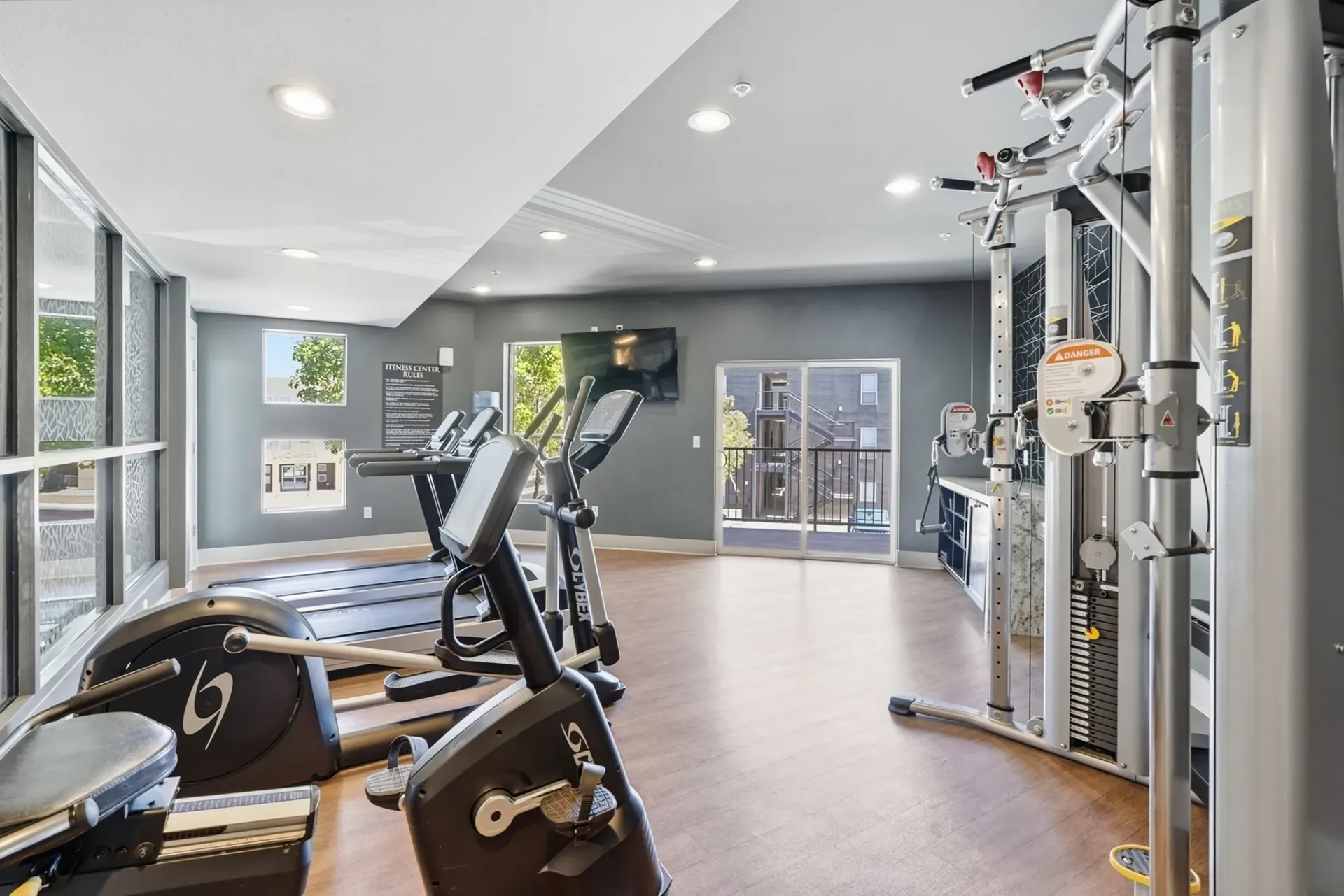 Treadmills, ellipticals, and weight machines in a well-lit fitness center at Solaire, offering apartments in Albuquerque, NM.