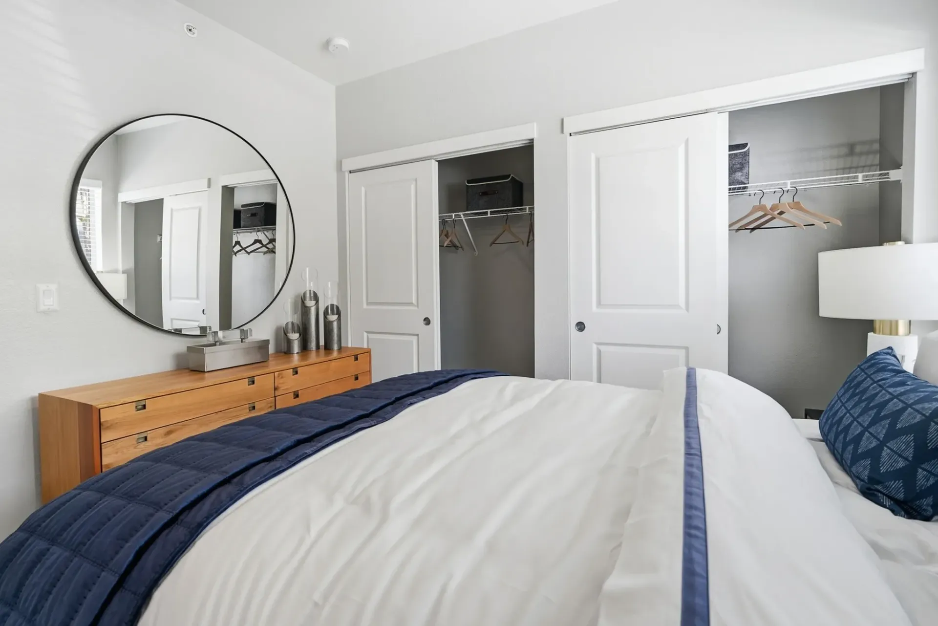 Bedroom with a large mirror, dresser, and closet at Solaire, offering apartments in Albuquerque, NM.