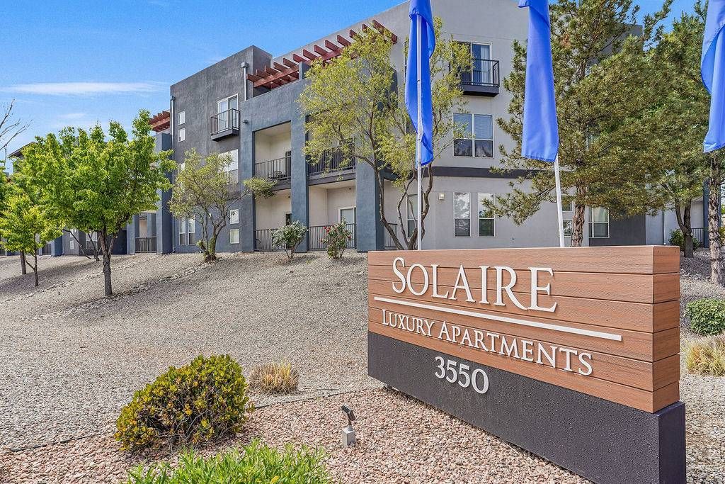 Exterior view of Solaire Luxury Apartments sign with building.