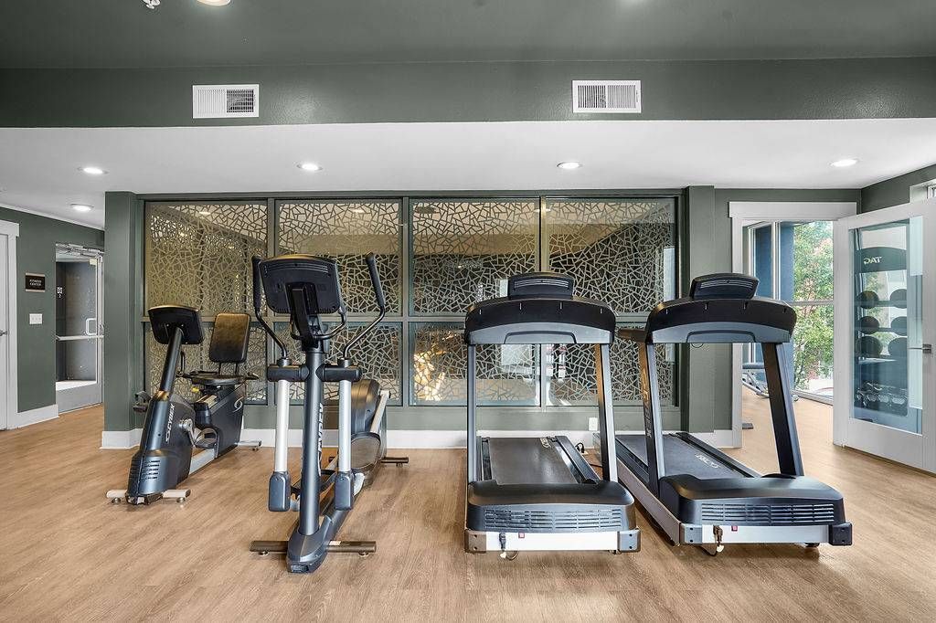 Gym area with treadmills and a stationary bike in a modern apartment community fitness center at Solaire Luxury Apartments, offering apartments for rent in Albuquerque, NM.