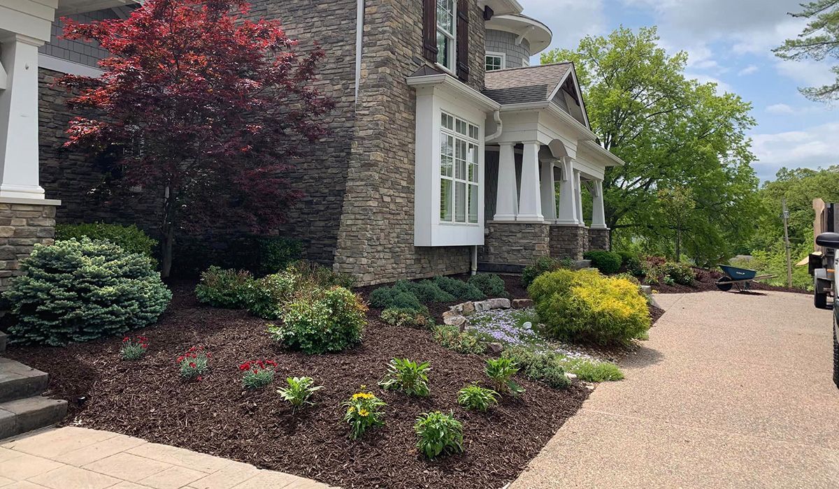 Large House with a Lot of Plants in Front — Saint Louis, MO — Zerr Lawn Care & Landscape LLC Large House with a Lot of Plants in Front — Saint Louis, MO — Zerr Lawn Care & Landscape LLC