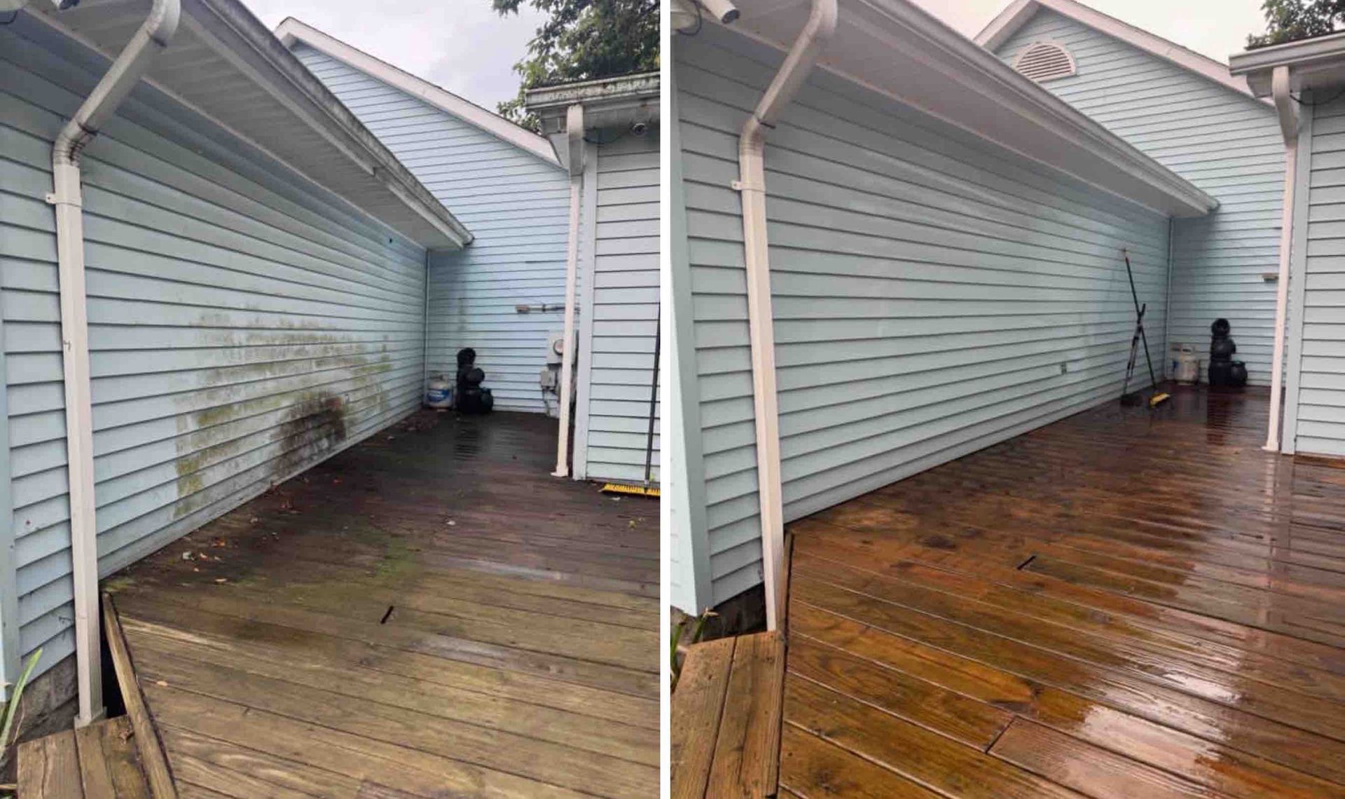 Two people clean a wet concrete entryway with a pressure washer and hose.