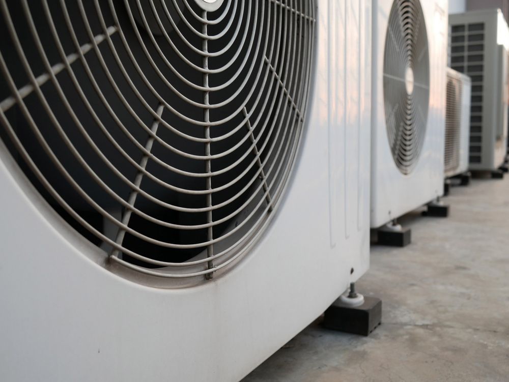 A Row of Heat Pumps Are Lined up On the Ground — Sunworks Eco Plumbing In Torquay, VIC