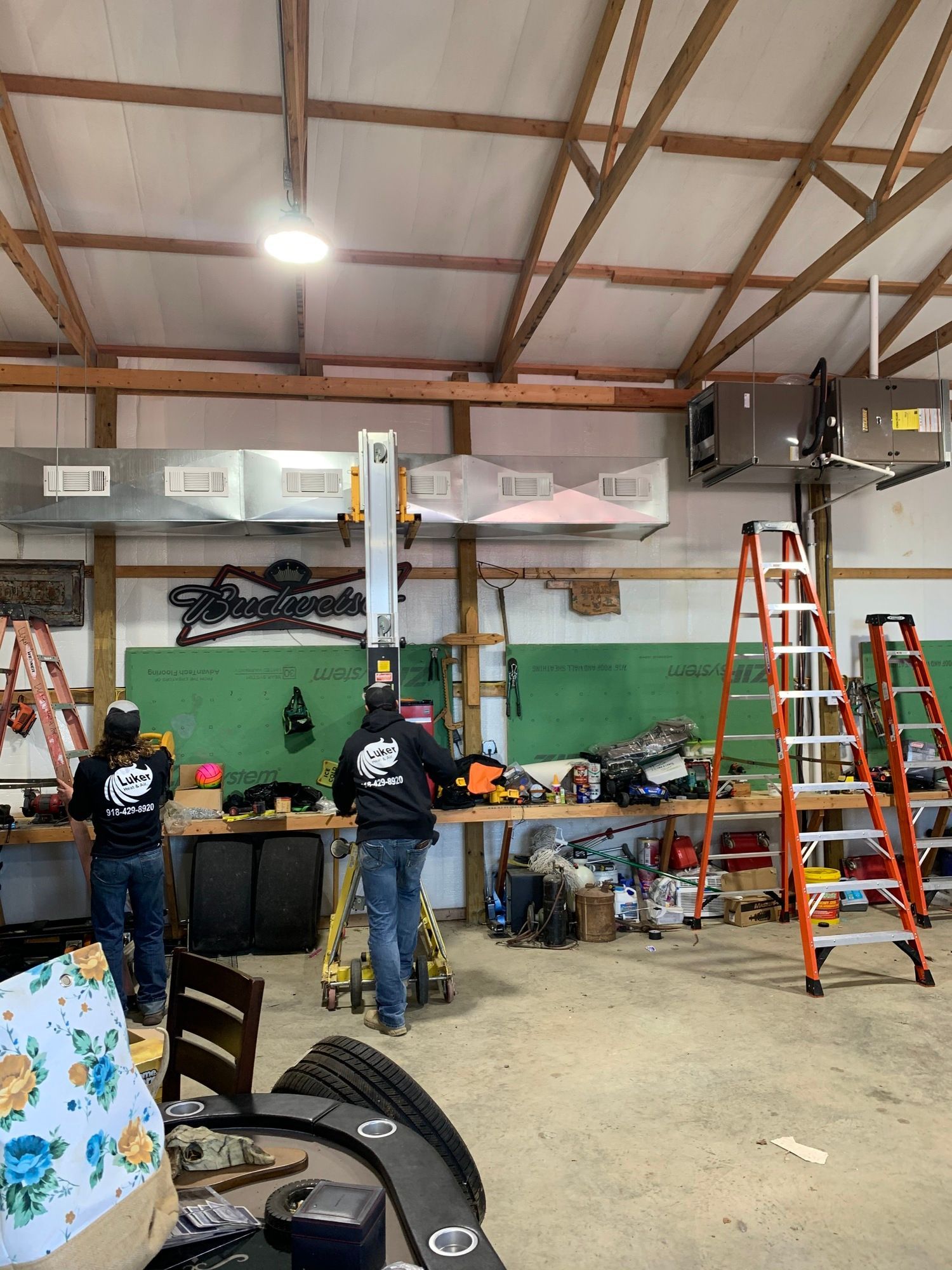 A group of men are working in a garage.