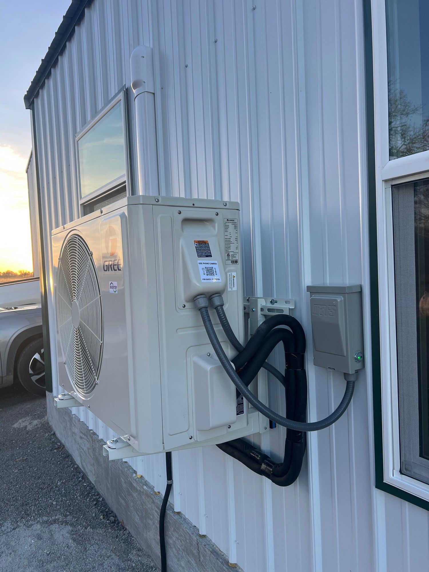 A large air conditioner is mounted on the side of a building.