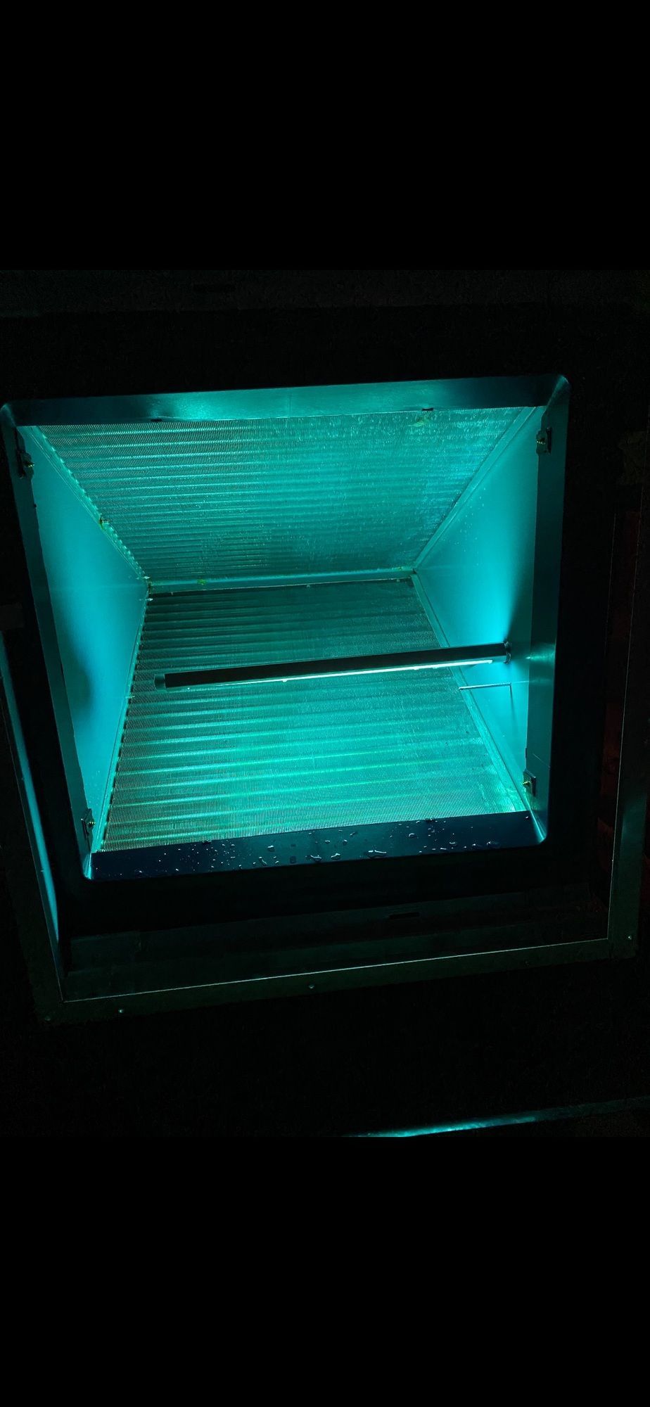 A toaster oven with a blue light coming out of it.