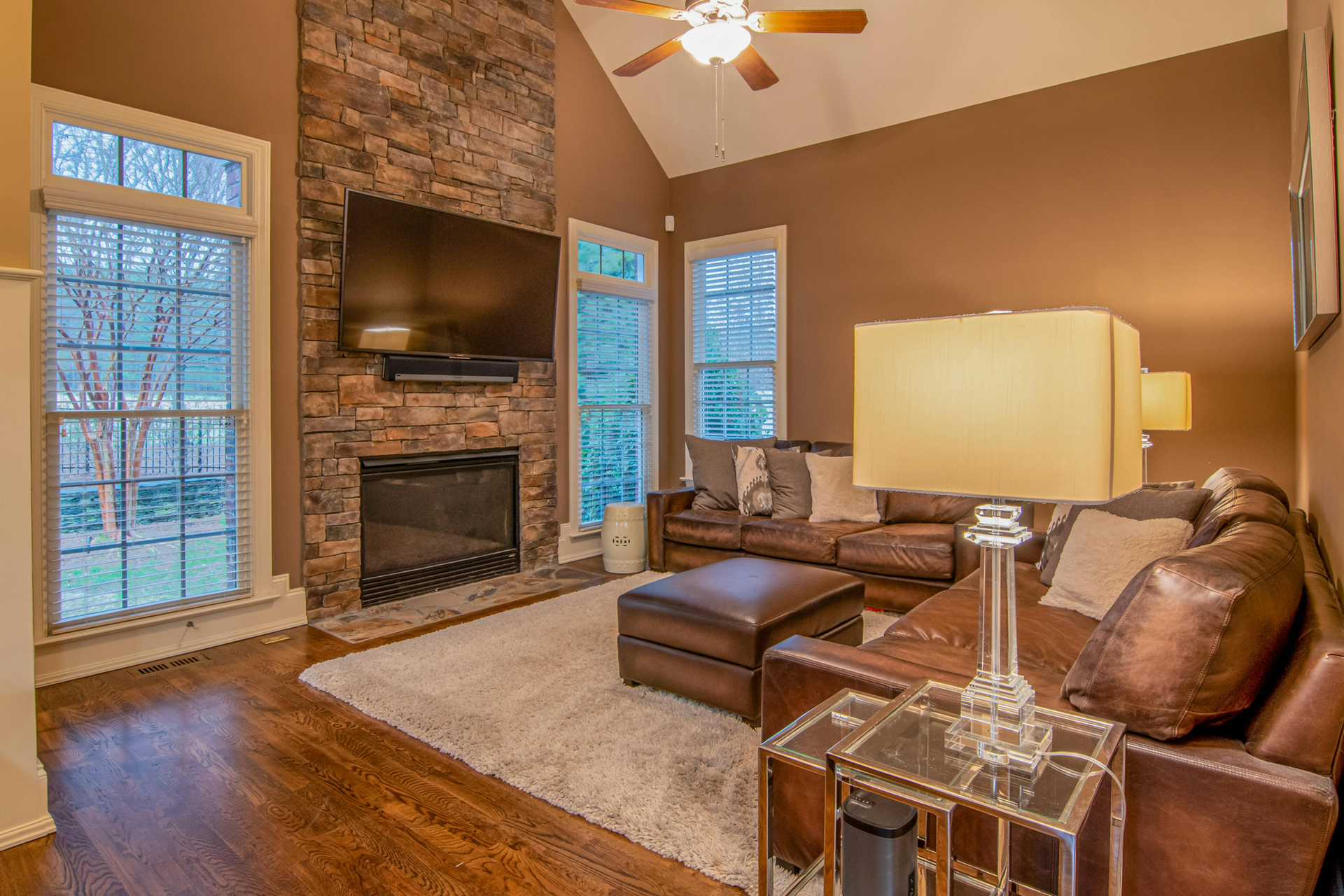 A wood stove is sitting in a living room next to a stack of logs.