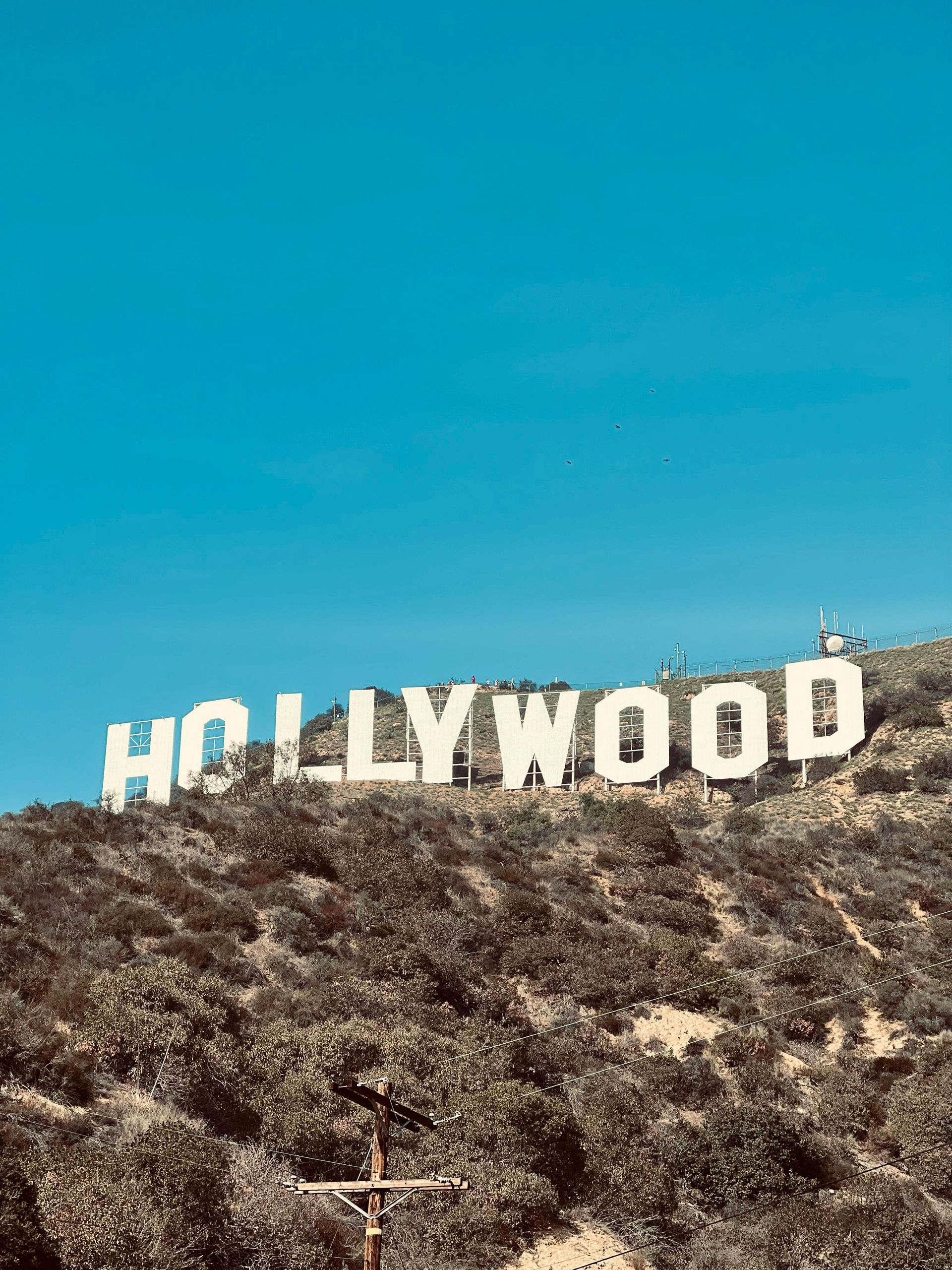 Hollywood sign on a dry hillside under a clear blue sky