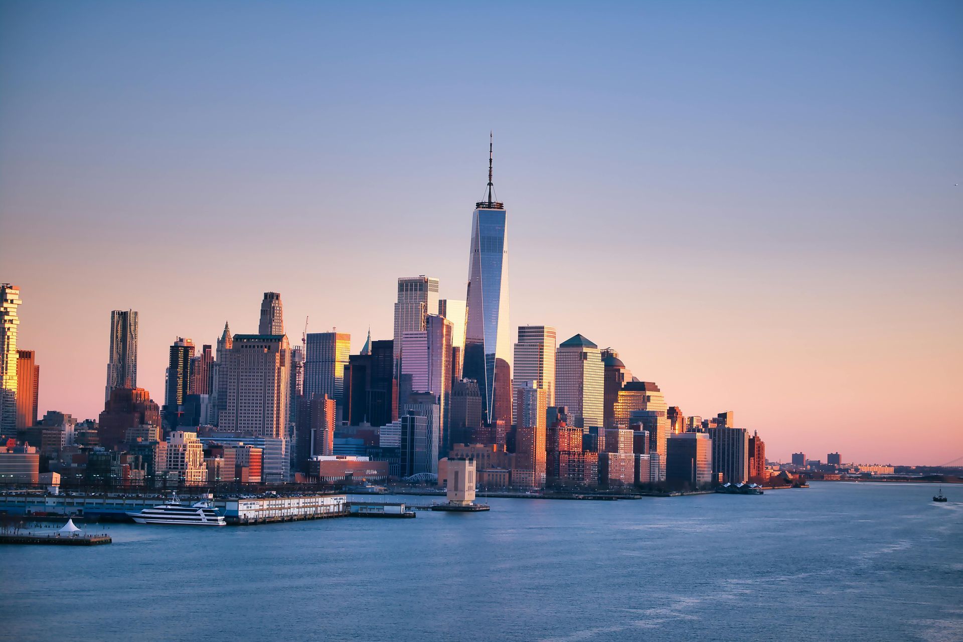 New York City skyline at sunset with One World Trade Center above the waterfront
