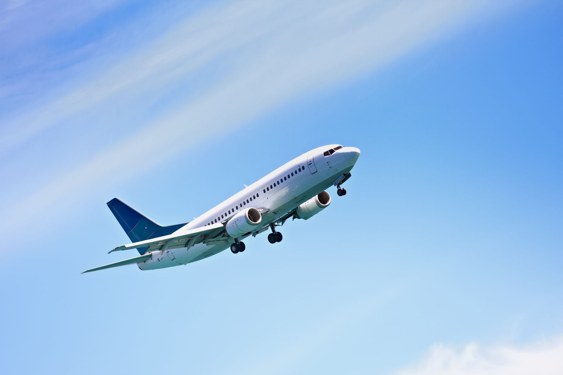 Commercial airplane taking off against a blue sky