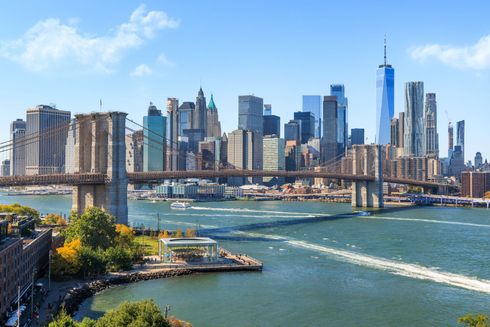 Skyline of Lower Manhattan and the Brooklyn Bridge over the East River on a clear day