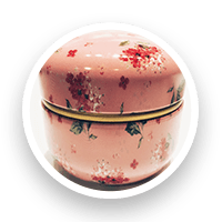 Pink floral tin with a rounded lid.