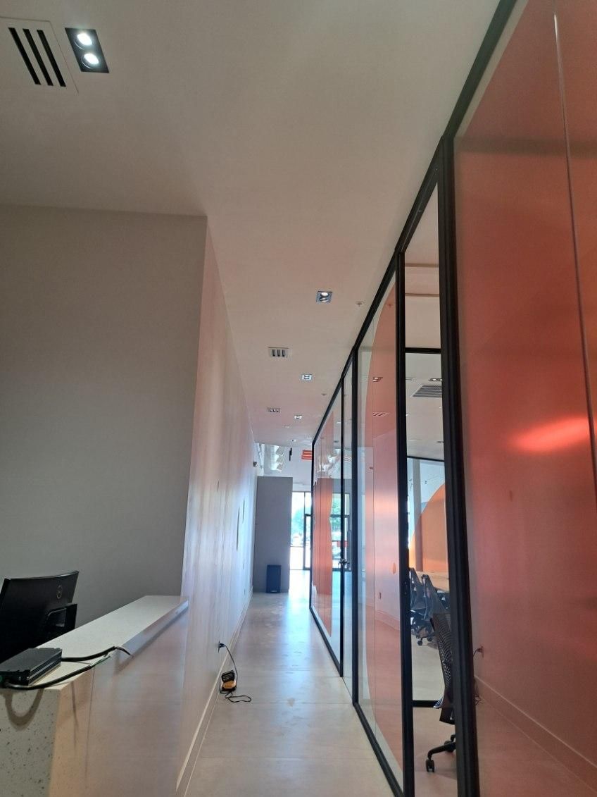 A long hallway leading to a reception desk in an office building.