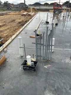 A construction site with a lot of pipes on the ground.