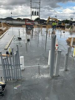 A construction site with a lot of pipes on the ground.