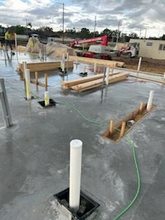 A construction site with a hose connected to a pipe.