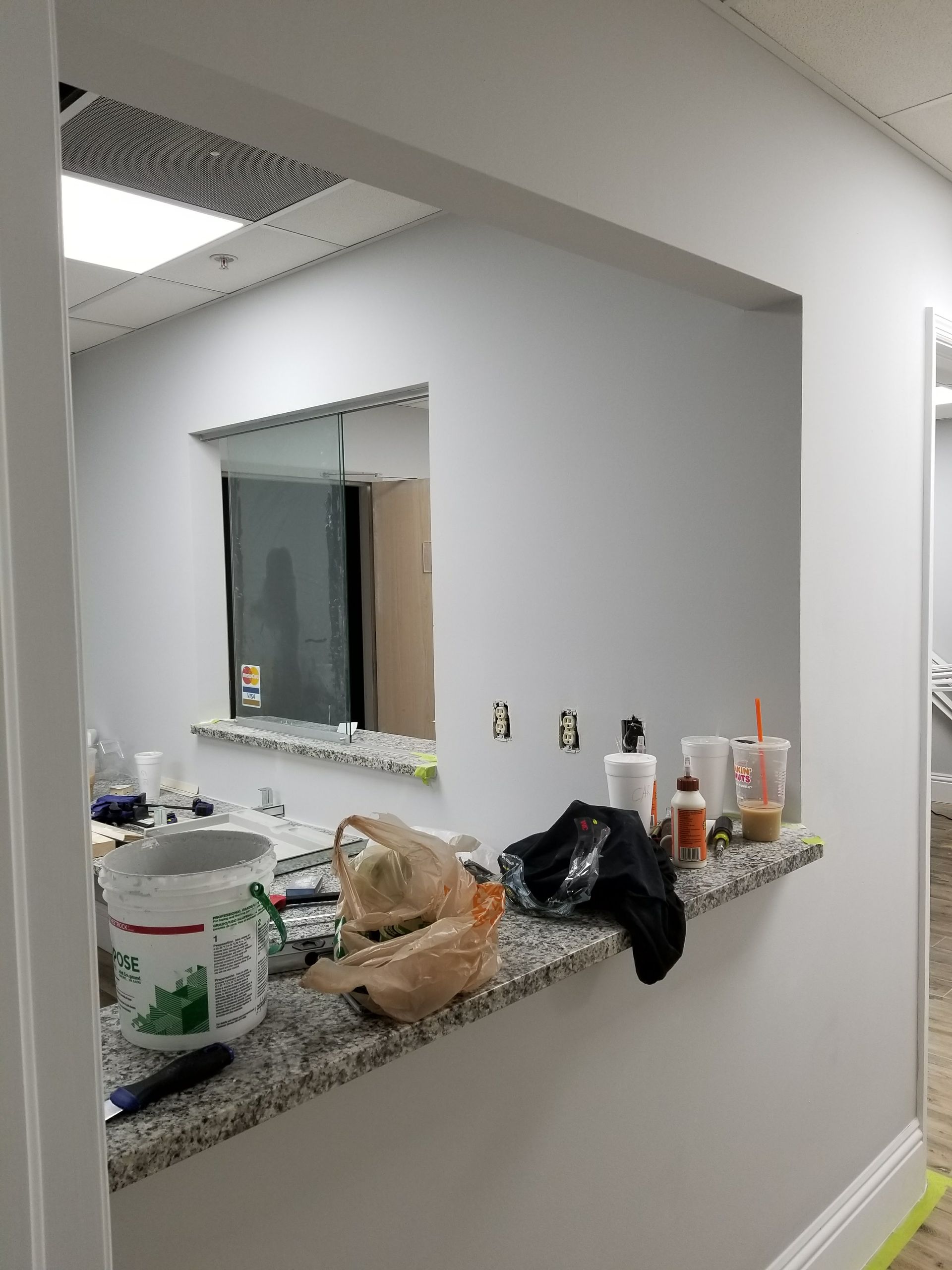 A kitchen with a counter top and a window.